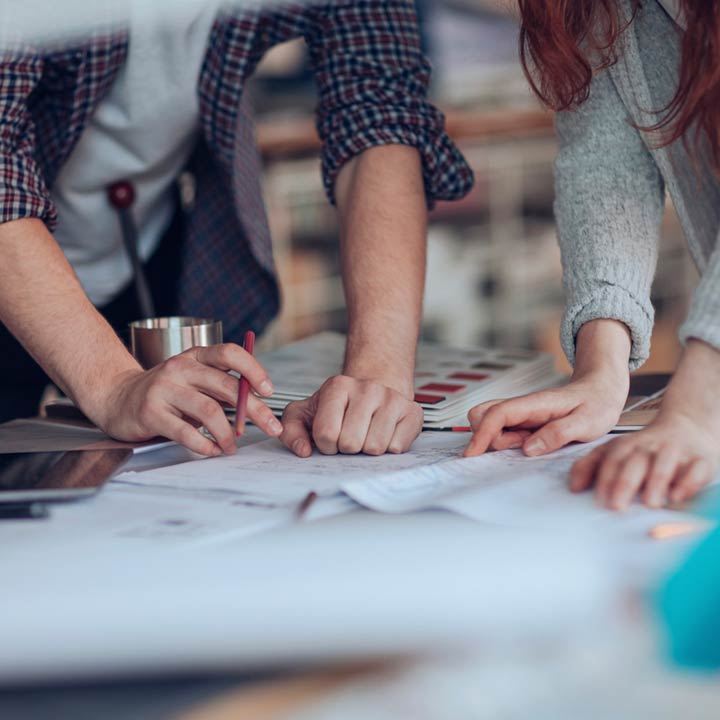 Two People Reviewing Survey Blueprint